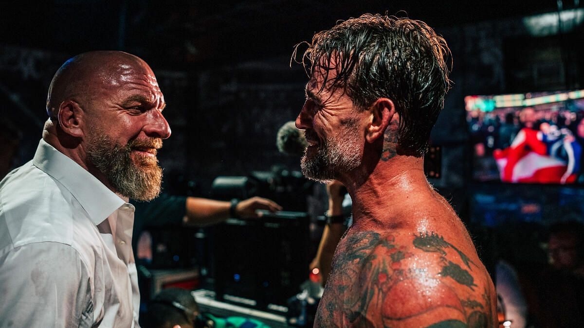 CM Punk with Triple H after his SummerSlam match